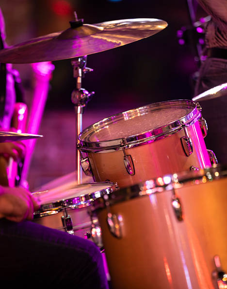 Percussion musician plays the drums during a country music rock concert